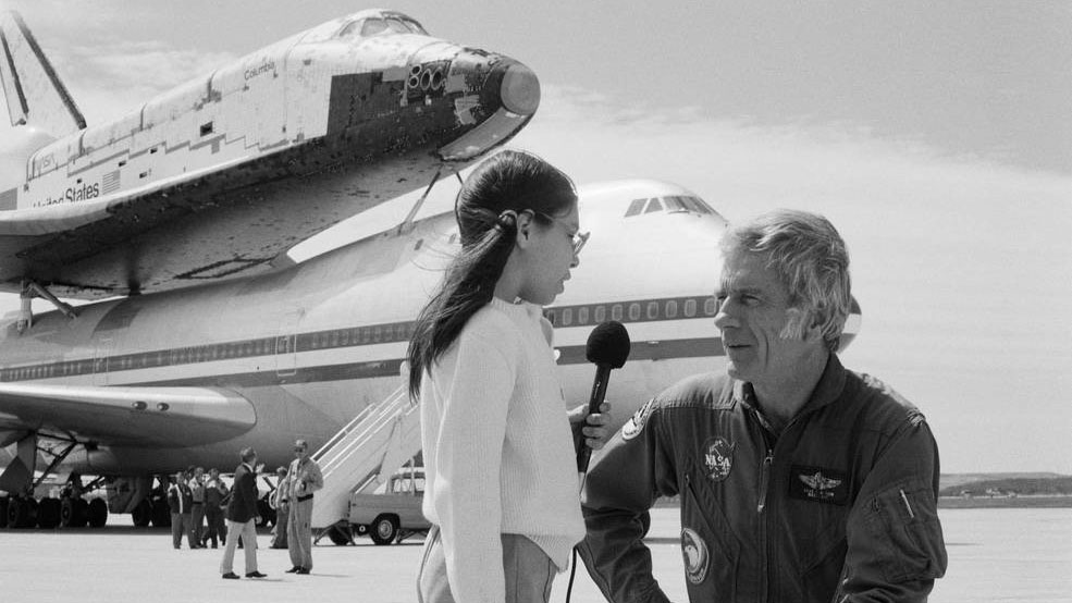 Astronaut Donald K. “Deke” Slayton being interviewed in front of Columbia and the Shuttle Carrier Aircraft during an overnight stop at Kelly Air Force Base in San Antonio on March 21, 1979.